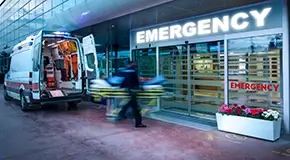Parked ambulance and EMT rushing to emergency room