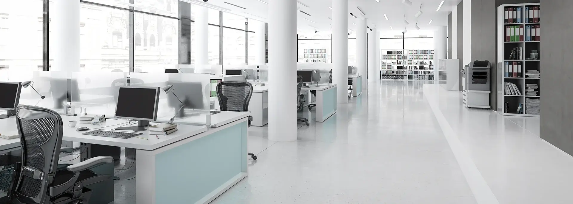 Sterile, white office space with large window panes in the background