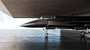 A jet fighter parked inside a concrete structure