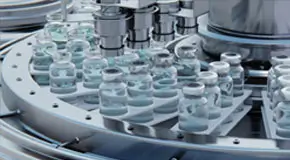 Machine puts caps on bottles vials passing on conveyor belt